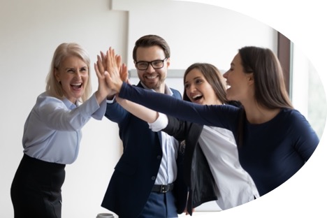 Building a cohesive team: a photo of four people giving a high five.