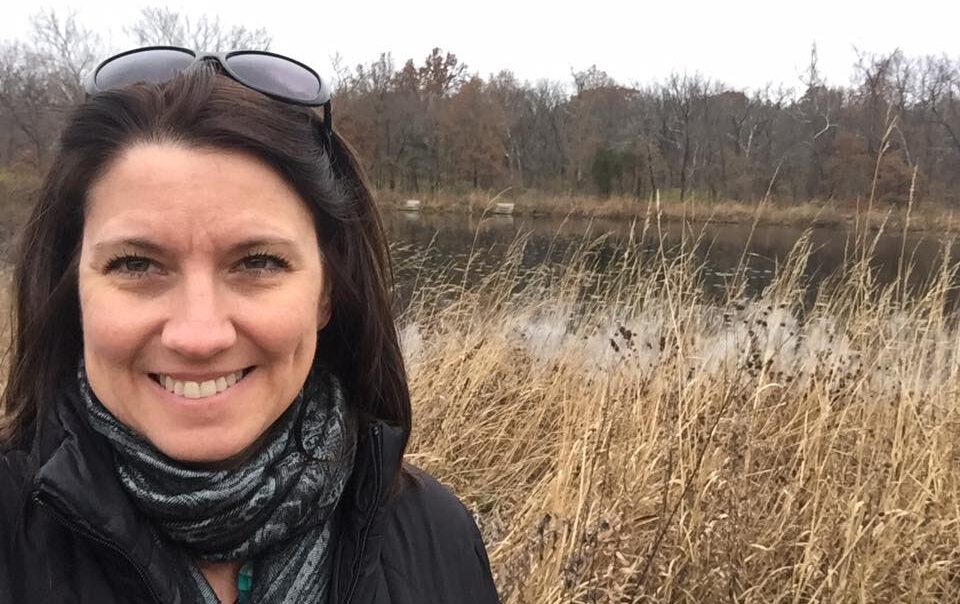 Carol Grubbe of Carol Grubbe LLC: Communication Made Simple out for a hike by a pond during fall. Carol helps companies to communicate effectively which can boost productivity, revenue, and morale.
